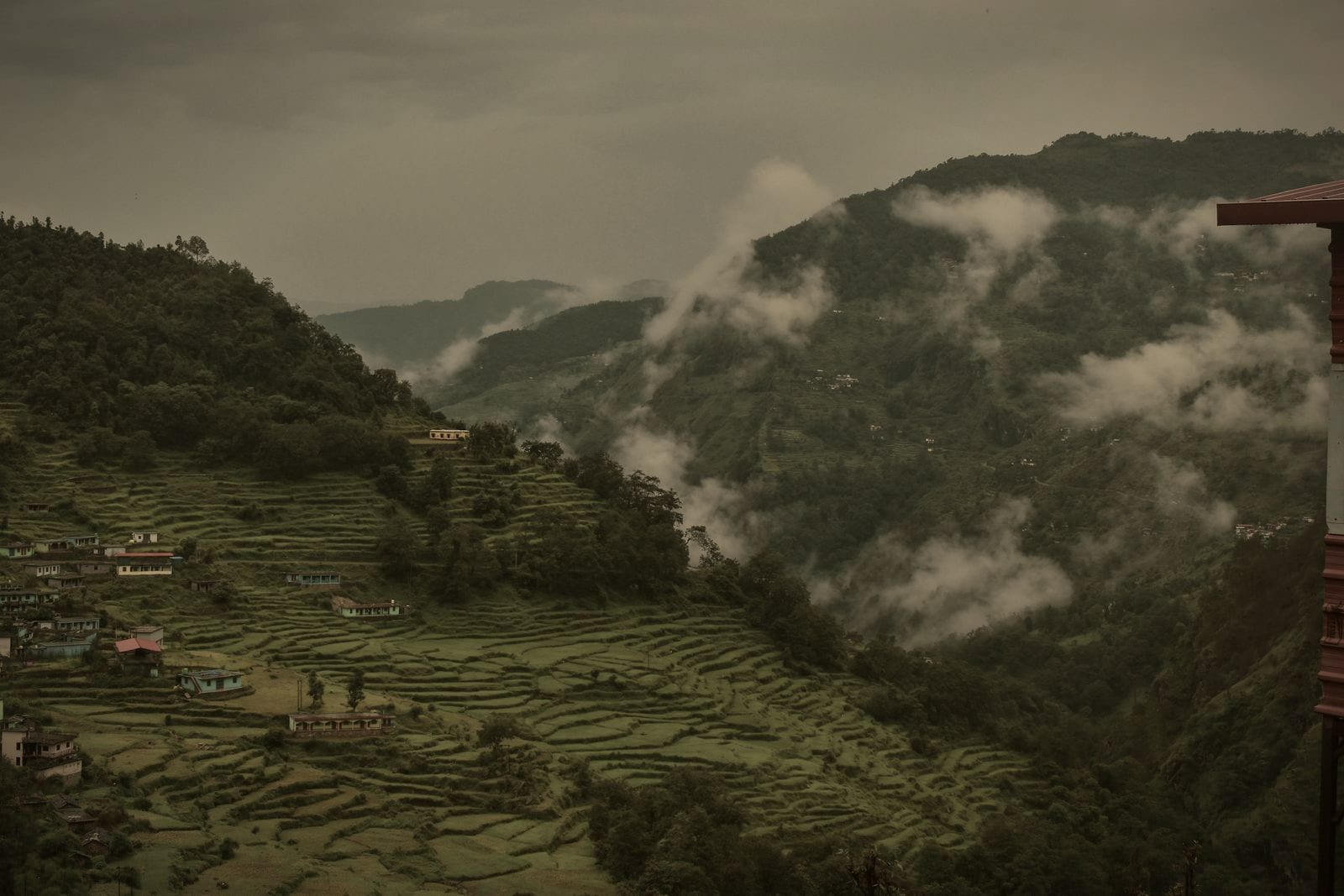 Terraced hillsides under drifting cloud near Ukhimath